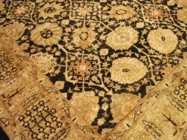 modern Persian-style wool rug black and gold 6-7 x 9-2