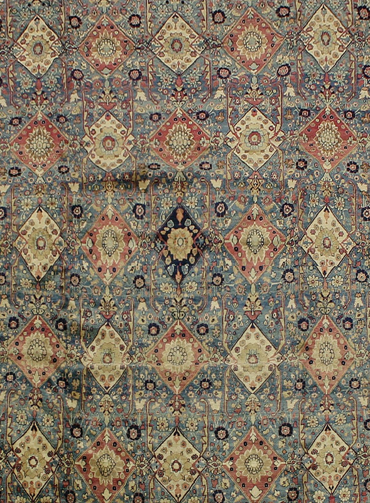 Antique Kerman rug with warm terracotta and antique blue colors, handmade wool weaving